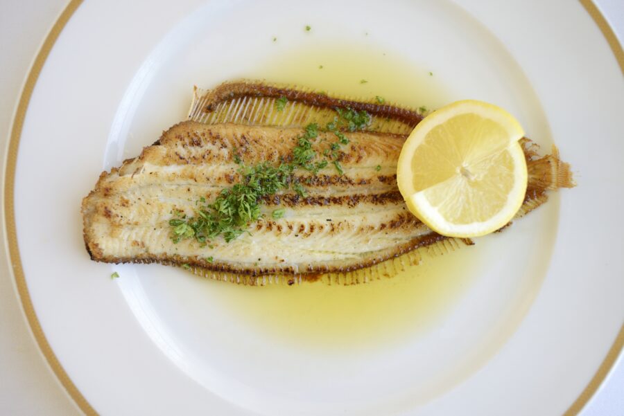 Sole Meuniere with fresh lemon on a white plate