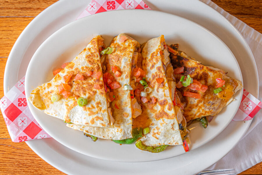 four quesadillas on a white plate