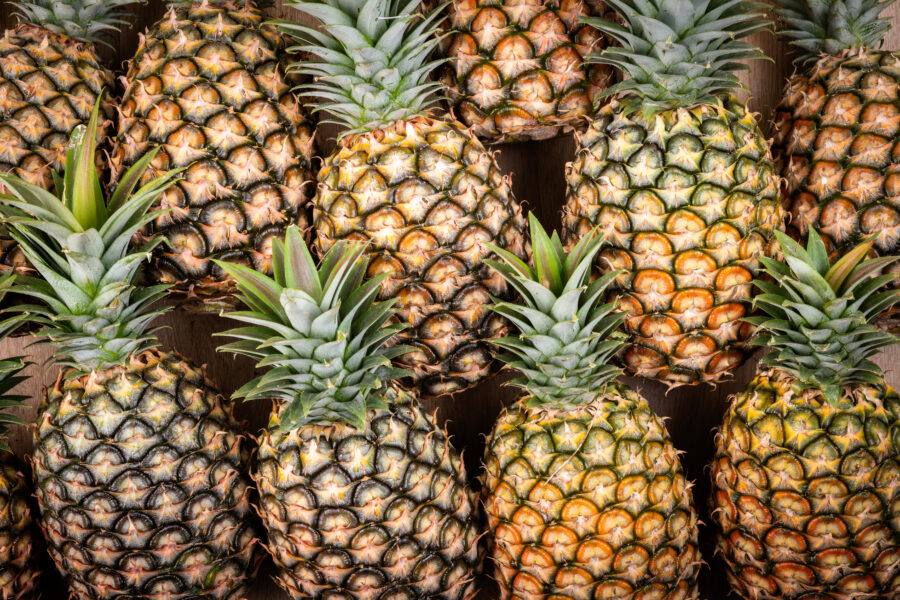 amount of fresh pineapple fruit in the market as a background