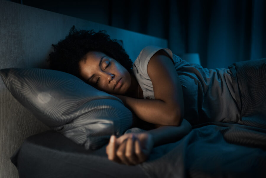 african american woman sleeping in her bed at night