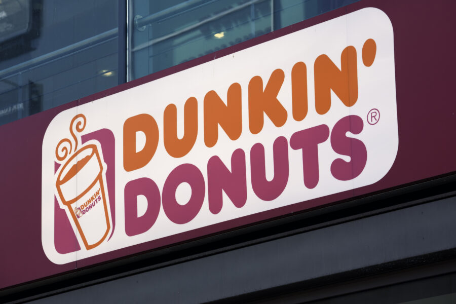 Dunkin Donuts logo sign at the entrance to one of their stores. 