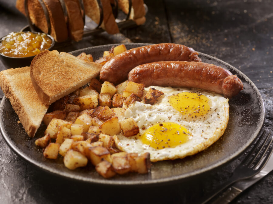 Breakfast with Sunny side up eggs, sausage, hash browns and toast