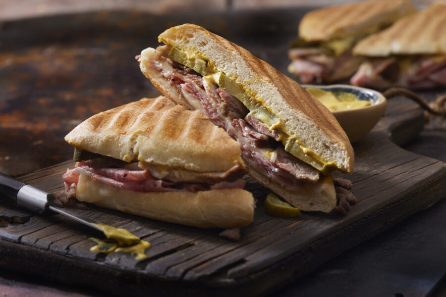 Classic Grilled Cuban Sandwich with Roast Pork, Honey Ham, Swiss Cheese, Dill Pickles and Mustard