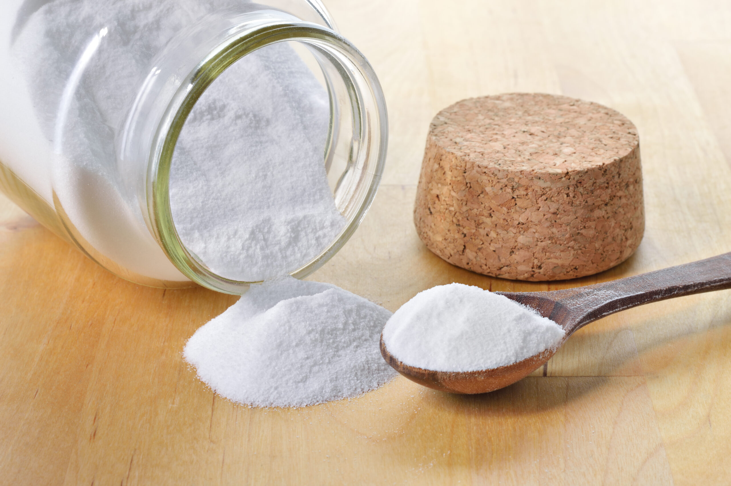 Close-up of baking soda in a glass jar. Bicarbonate of soda.