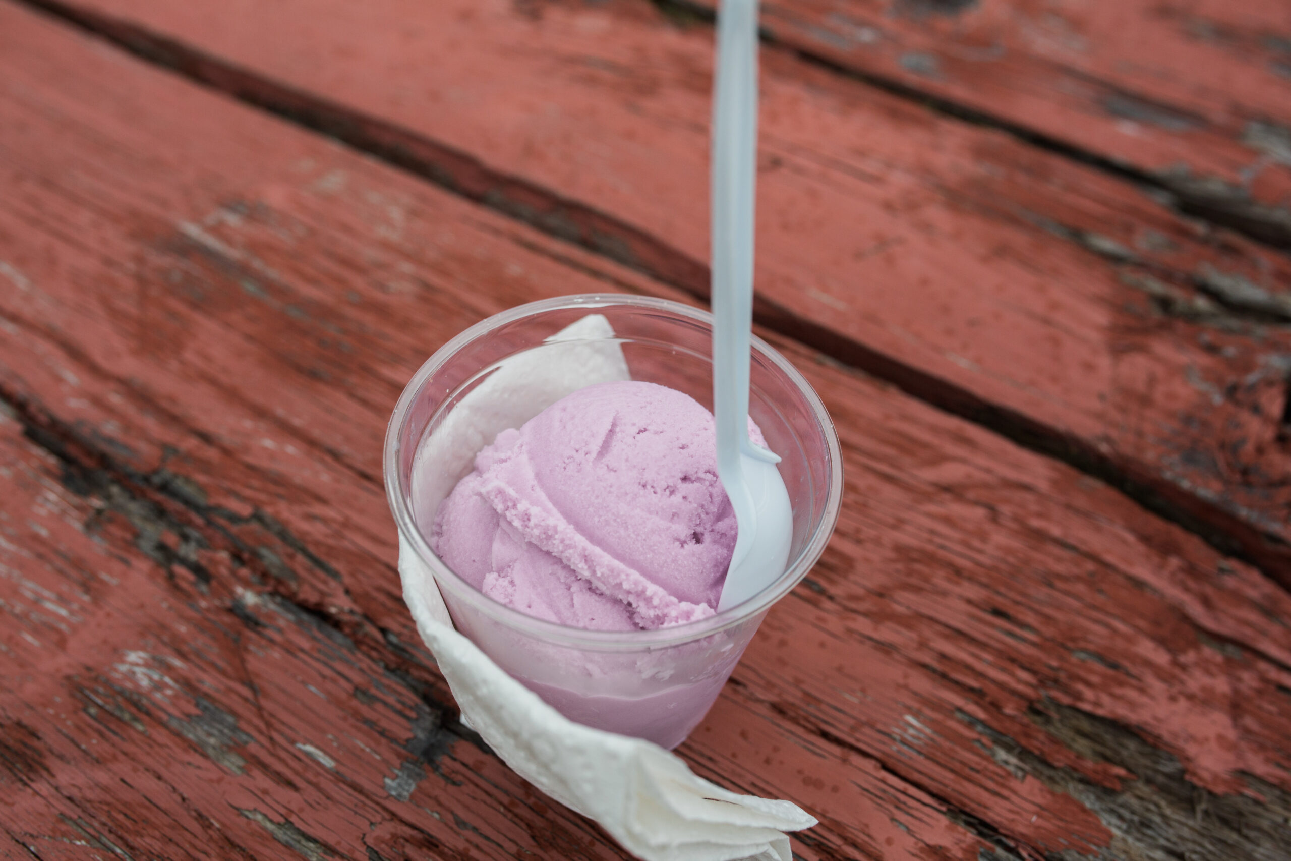 Close up shot of pink fireweed ice cream on wood table