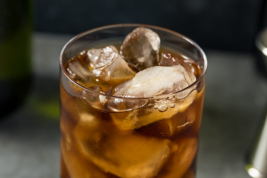 glass of cola with ice cubes