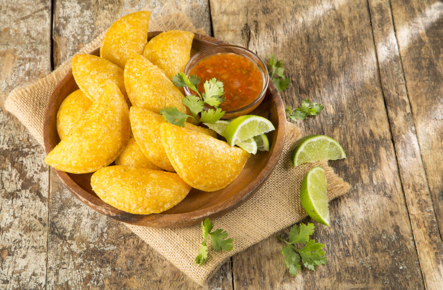 Colombian empanada with spicy sauce