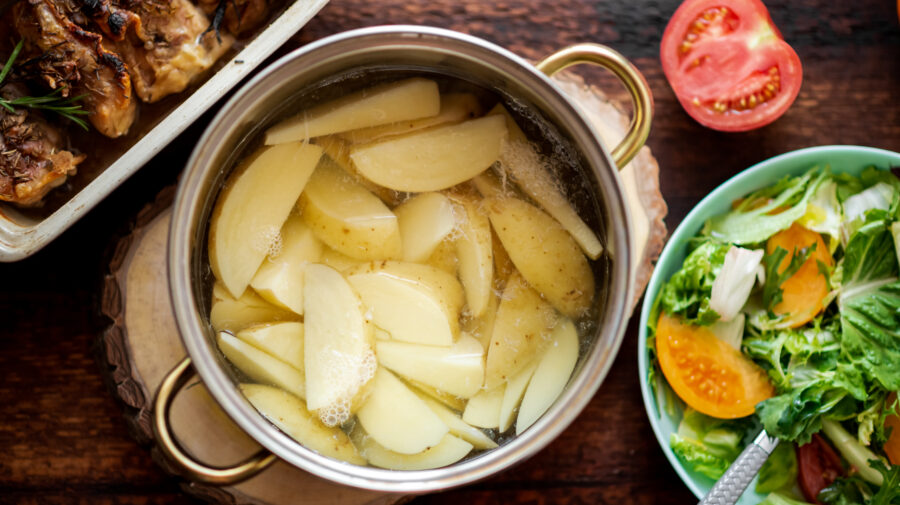 Cooking boiled young potatoes in a saucepan.