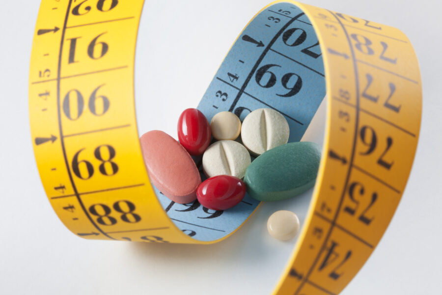 Diet pills and measuring tape