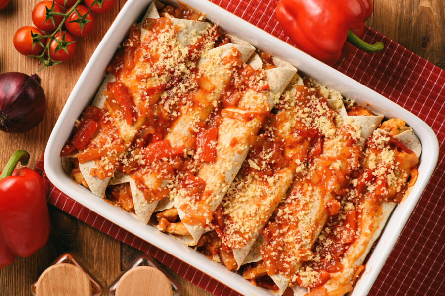 Enchiladas - mexican food, tortilla with chicken, cheese and tomatoes.