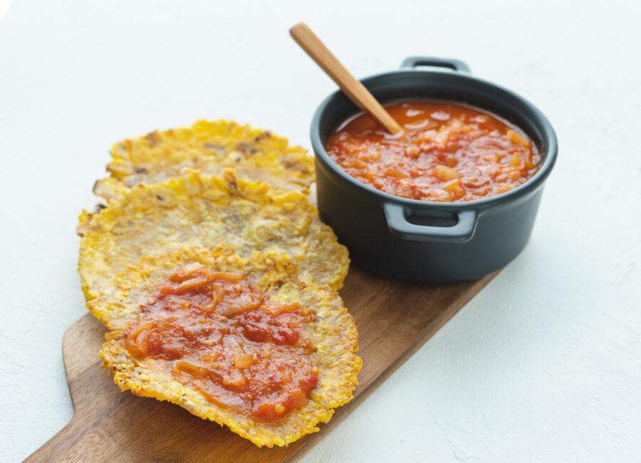 Fried banana with fried tomato on a white background. 