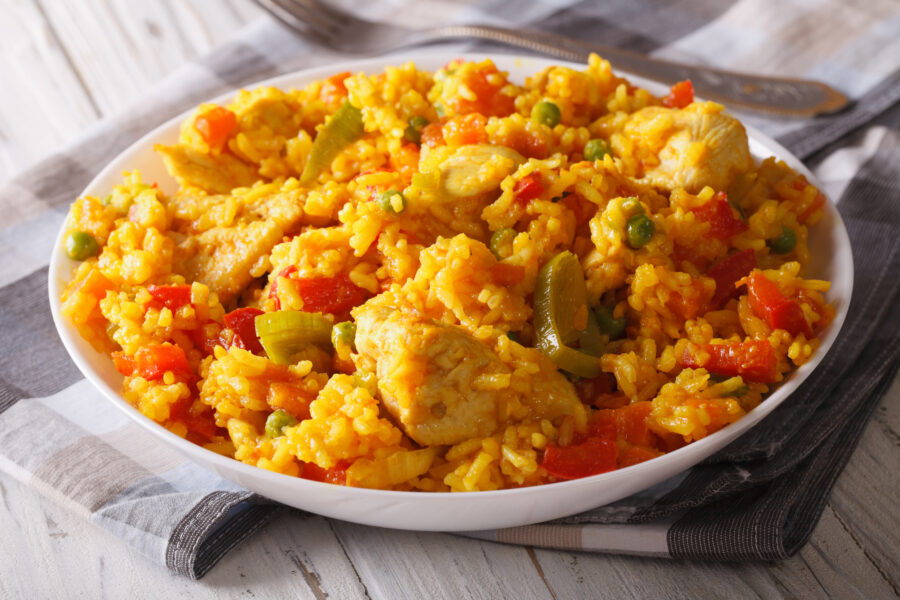 Arroz con pollo - rice with chicken close up in a bowl on the table. Horizontal