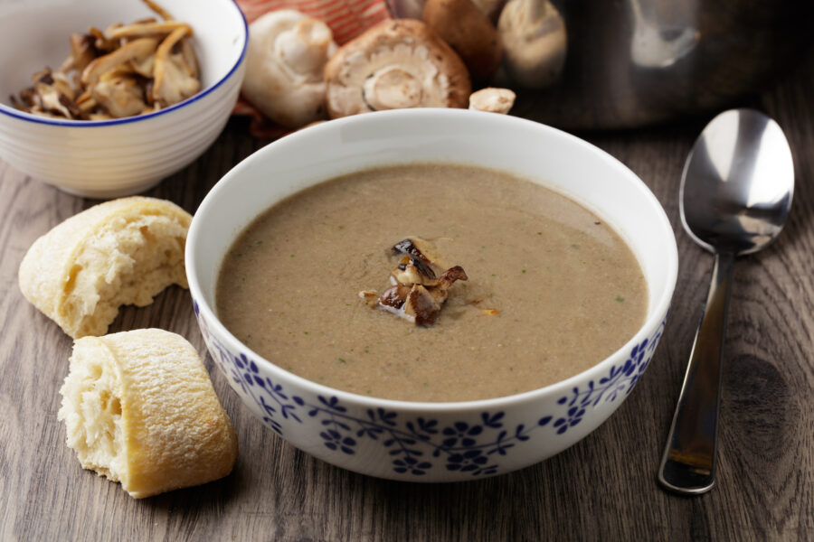 Homemade mushroom soup with crusty bread roll