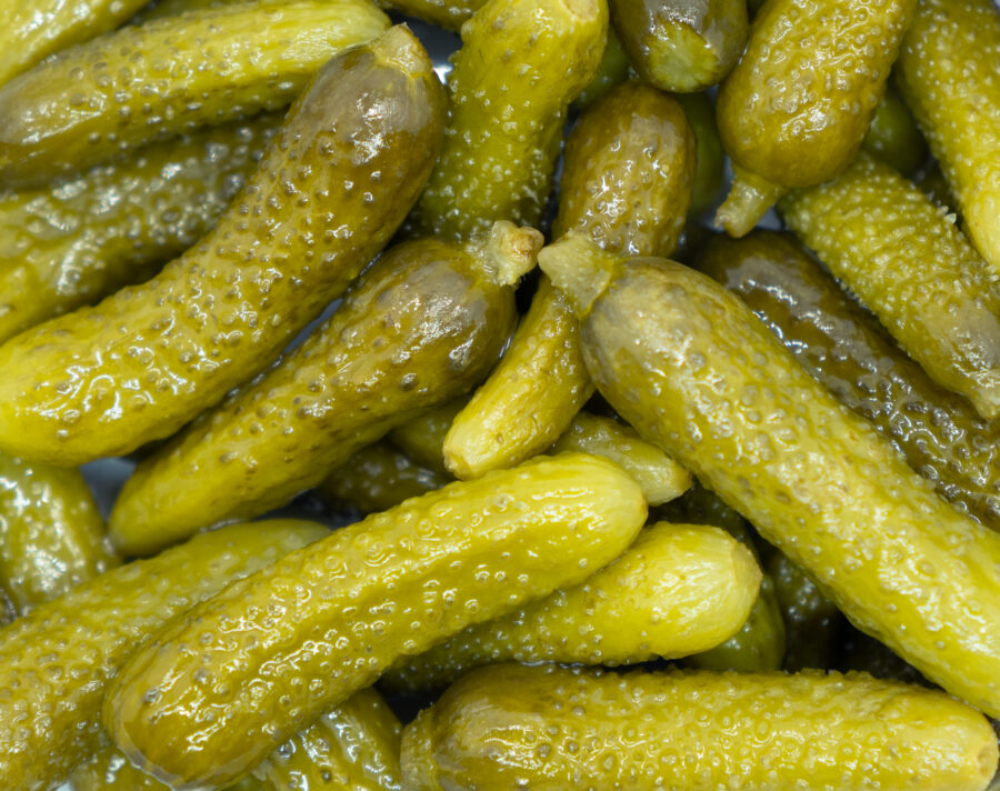 Marinated cornichons texture food background.