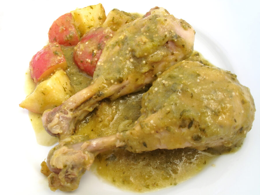 Photo of chicken drumsticks prepared with green tomatillo sauce.  