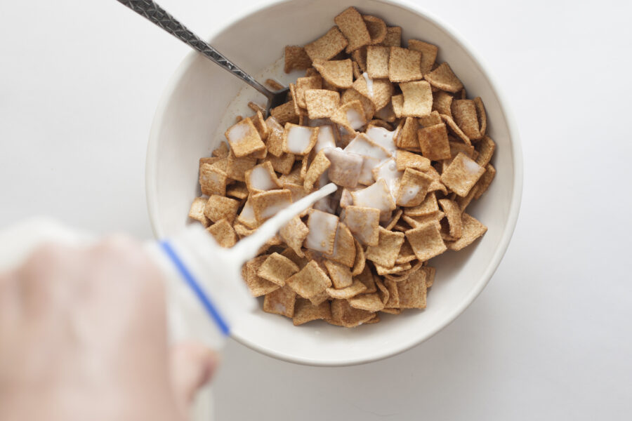 Pouring Milk Over Cinnamon Toast Crunch Cereal