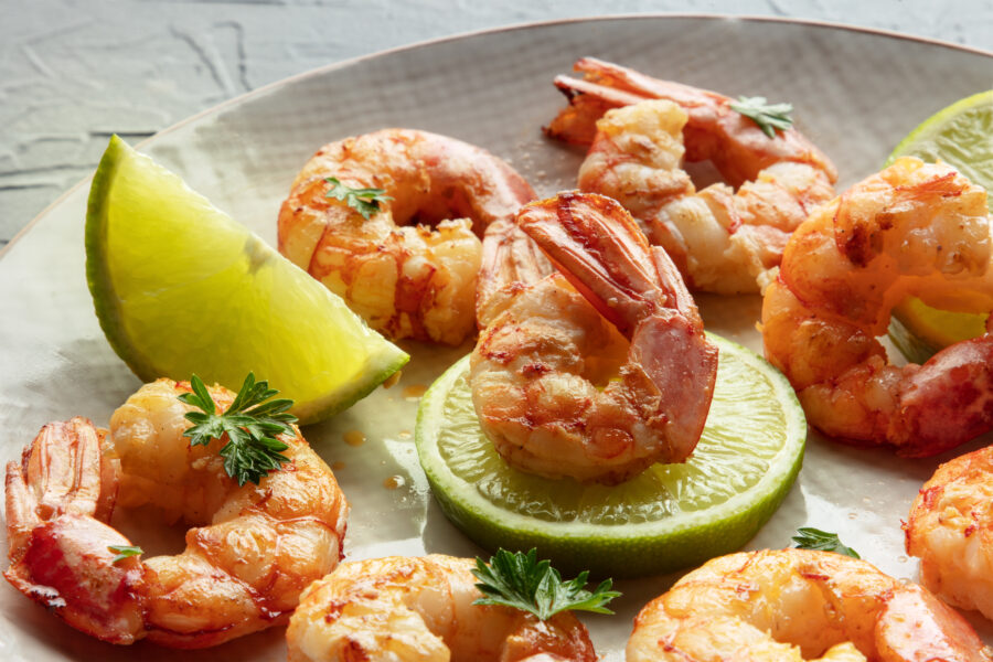 Shrimps close-up. Fried shrimp with lime on a plate.