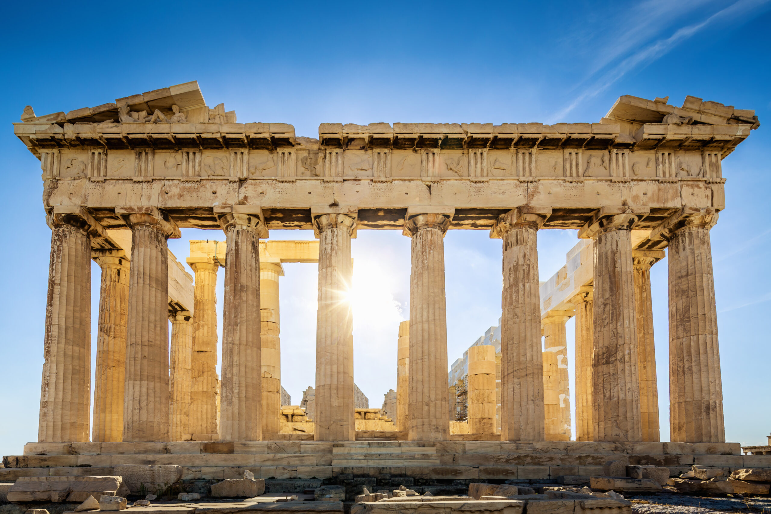 The Parthenon on the Athenian Acropolis, Sun shining through the columns. The Temple is dedicated to the Greek Goddess Athena. Athens, Greece.