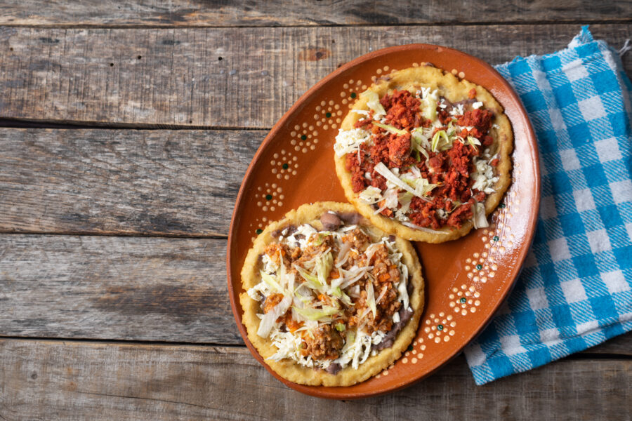 Traditional mexican food: sopes of Chorizo and beef picadillo with cheese and beans