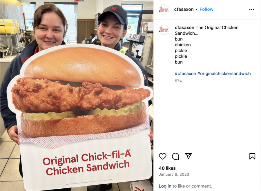 Instagram post showing workers holding a cardboard cutout of Chick-fil-A's original chicken sandwich, by @cfasaxon