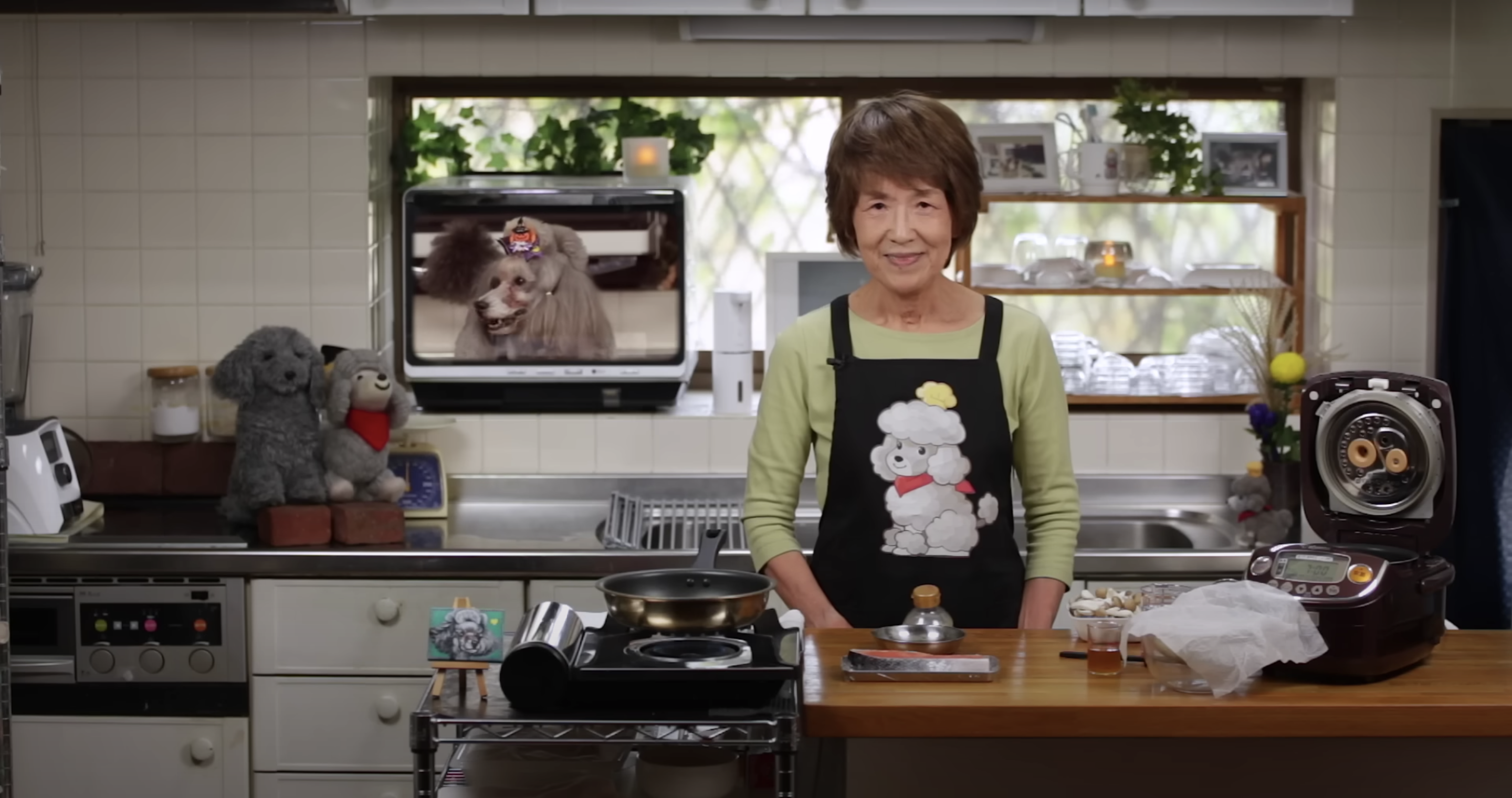 Image of Chef and Francis from "Cooking with Dog" in a kitchen, from YouTube video "Salmon & Mushroom Rice Cooker Recipe for Takikomi Gohan Mixed Rice"