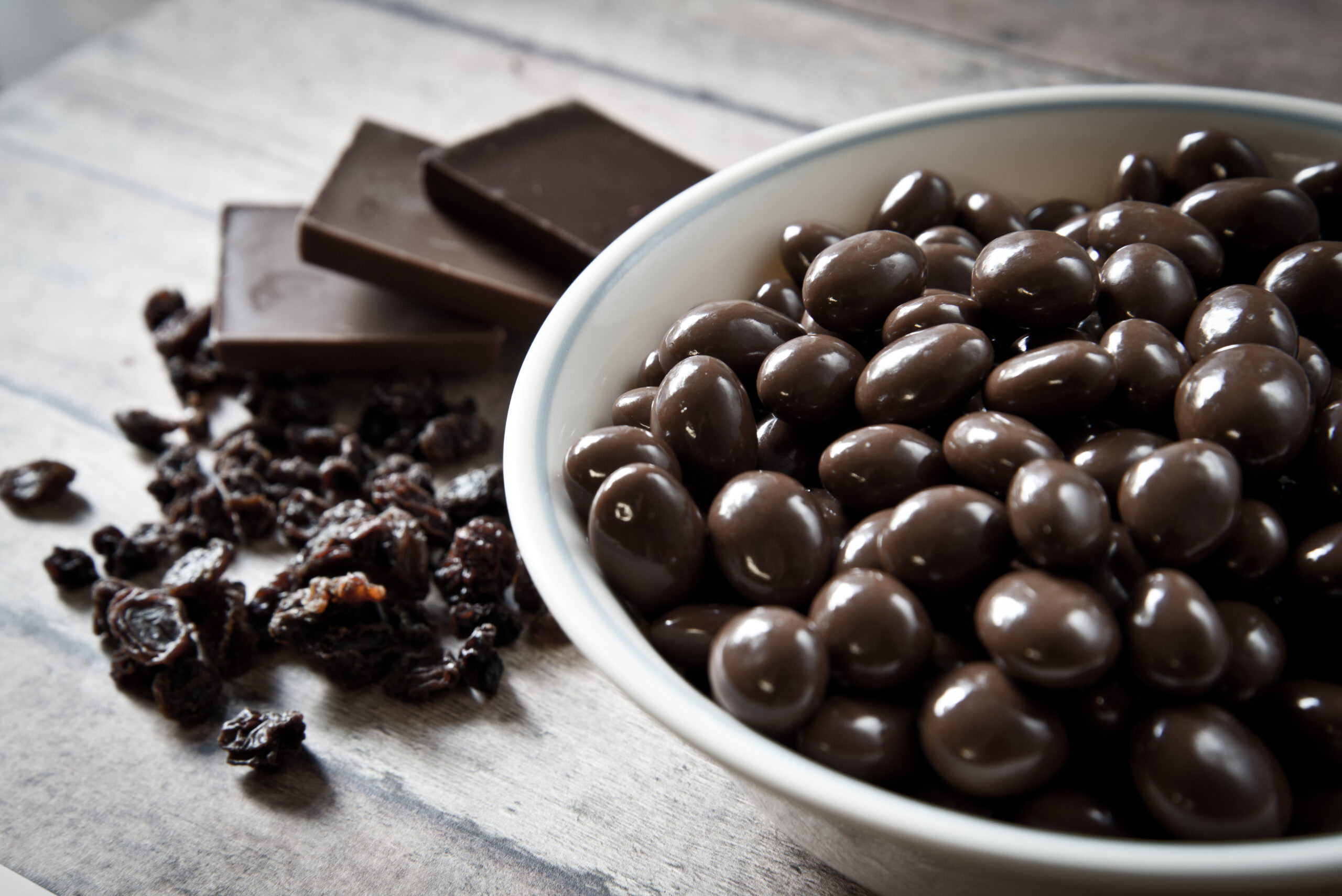 A bowl with chocolate coated raisins or berries