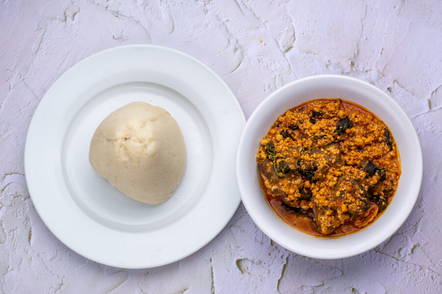 An Image of the Nigerian cuisine called Egusi soup served with fufu / pounded yam from top view.