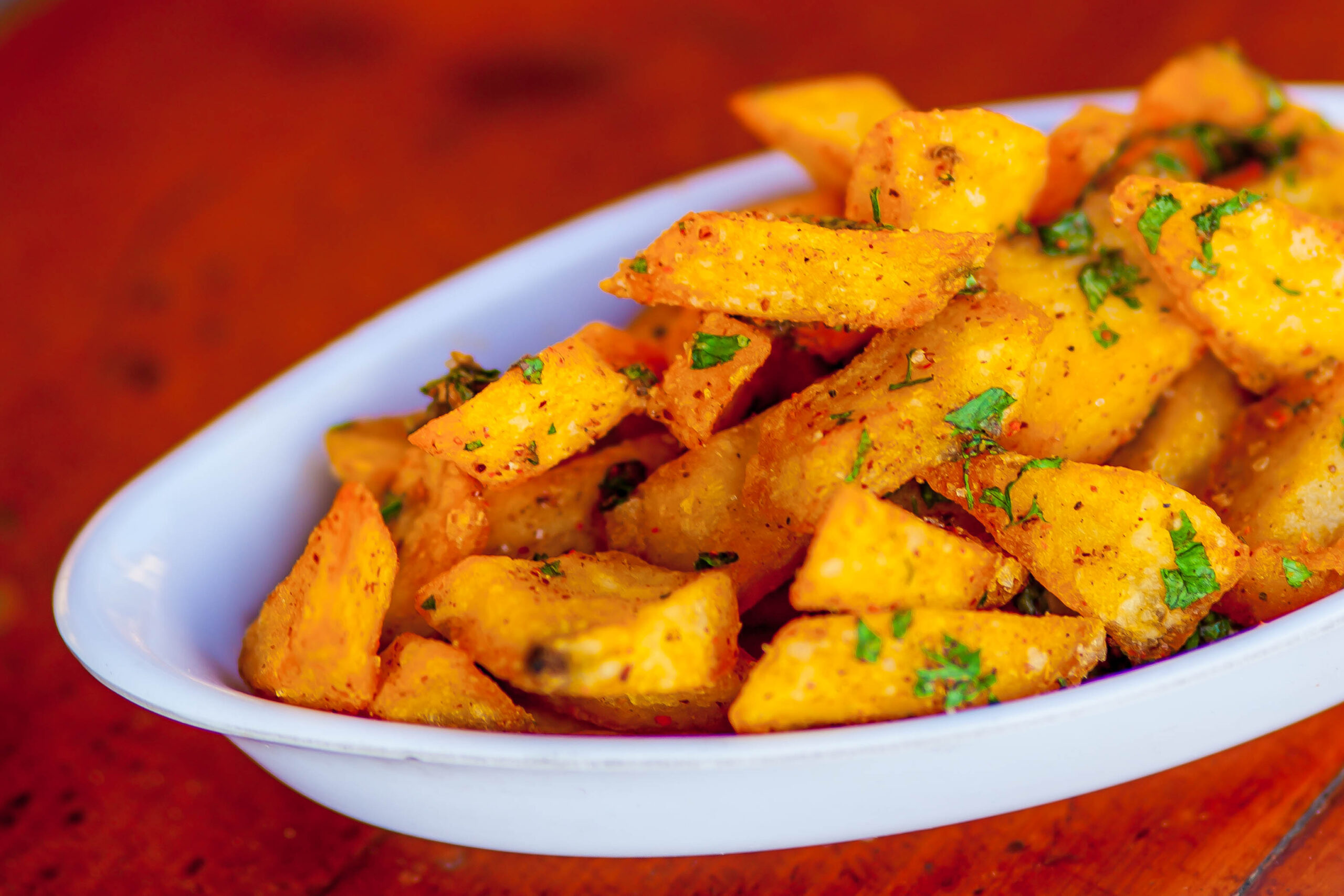 Baked fried potatoes on white plate