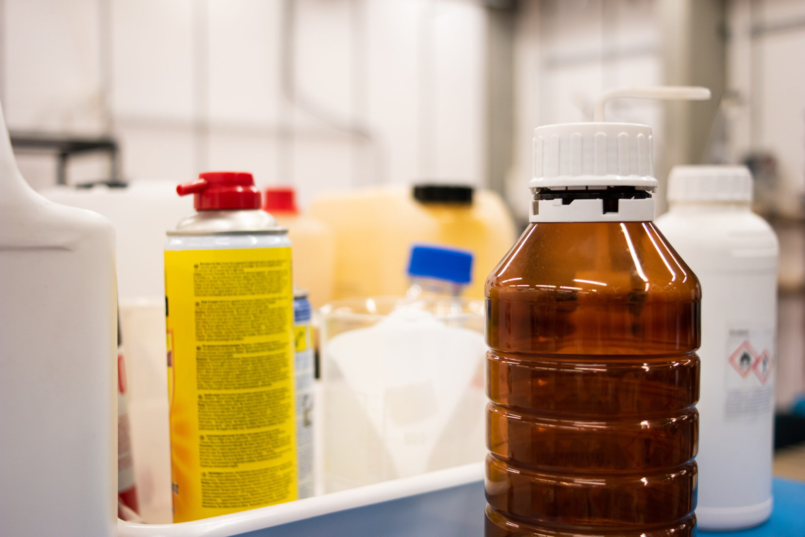 Brown non descript chemical plastic container in a laboratory set close up shot shallow depth of field.