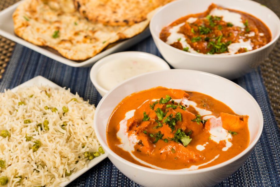 Butter chicken curry, lamb vindaloo, basmati rice, nan bread and yoghurt raita