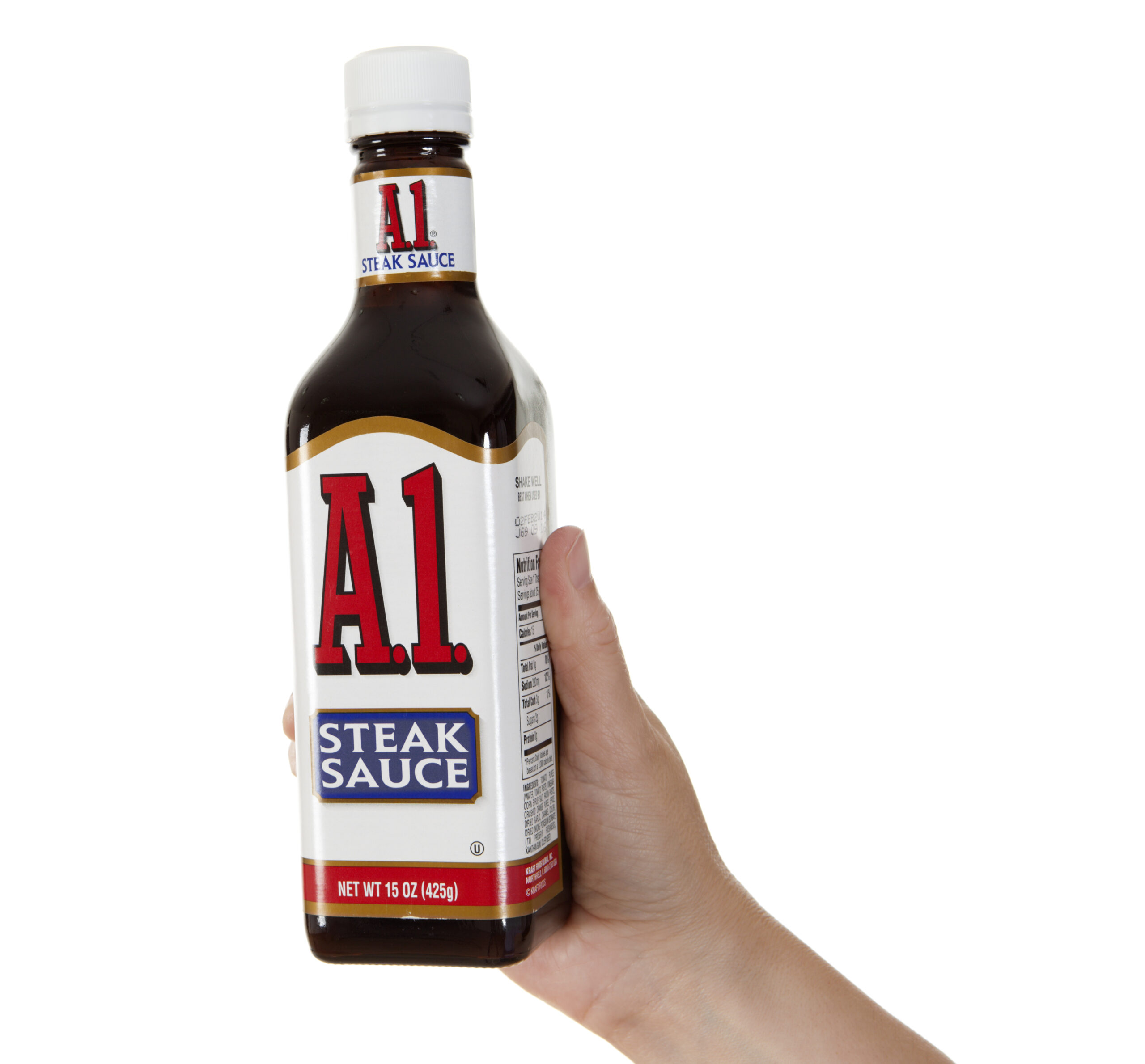 Chillicothe, Ohio, USA - July 5th, 2011: Hand holding a bottle of A1 Steak Sauce, by Kraft Foods Global, Inc. Studio isolated on a white background.