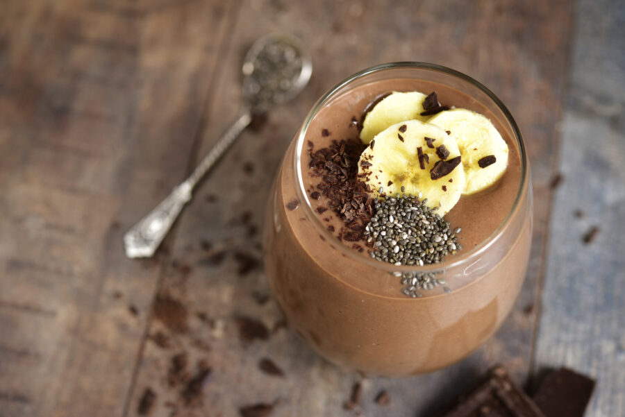 Chocolate banana smoothie with  chia seed on a rustic table.