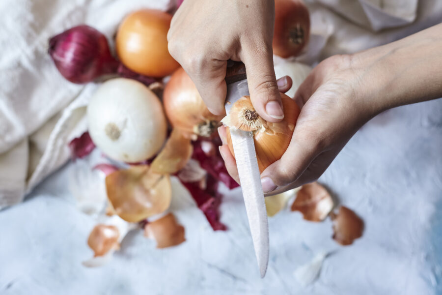 Cleaning fresh onions in the kitchen. Top view