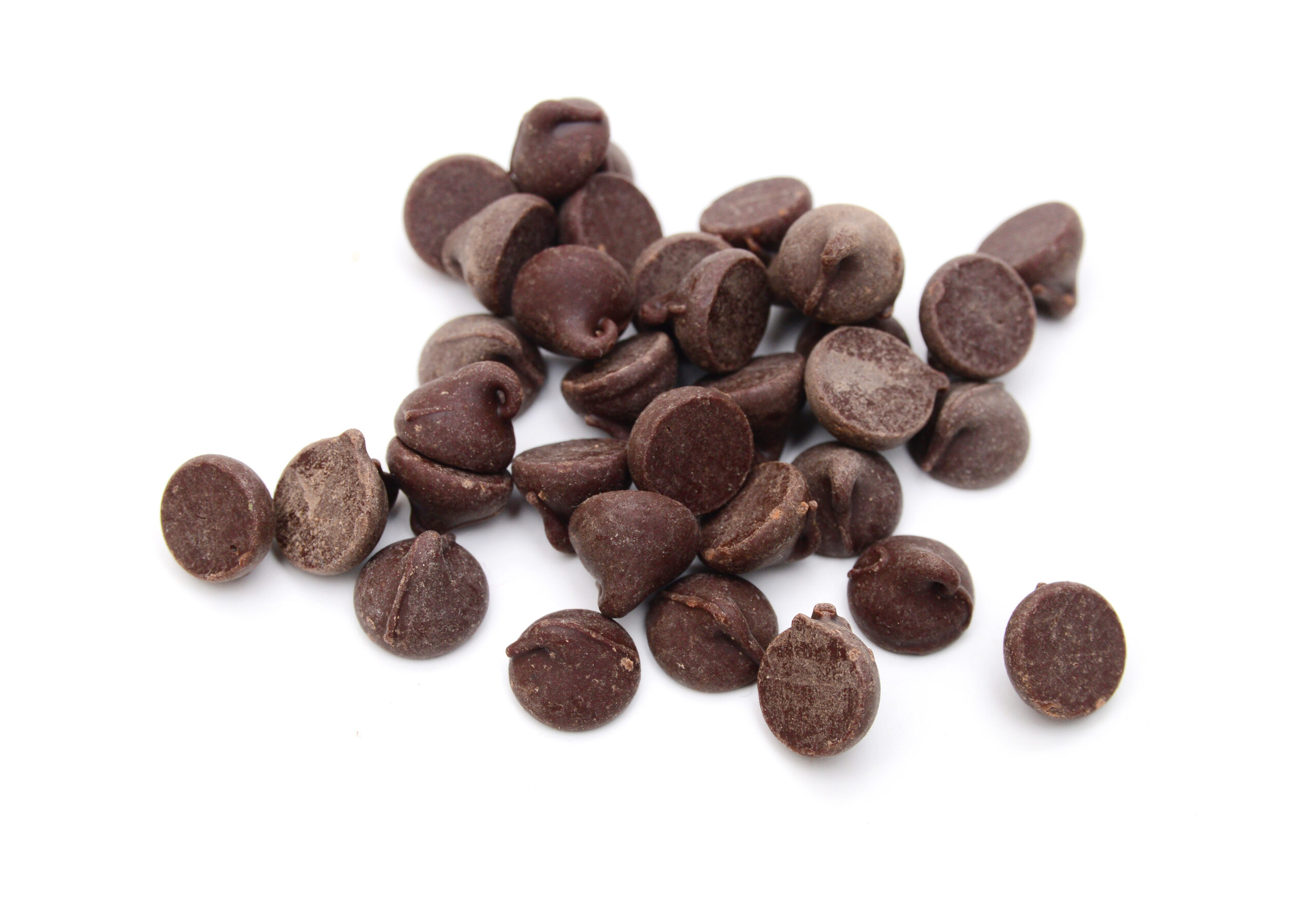 Close up pile of chocolate morsels on white background