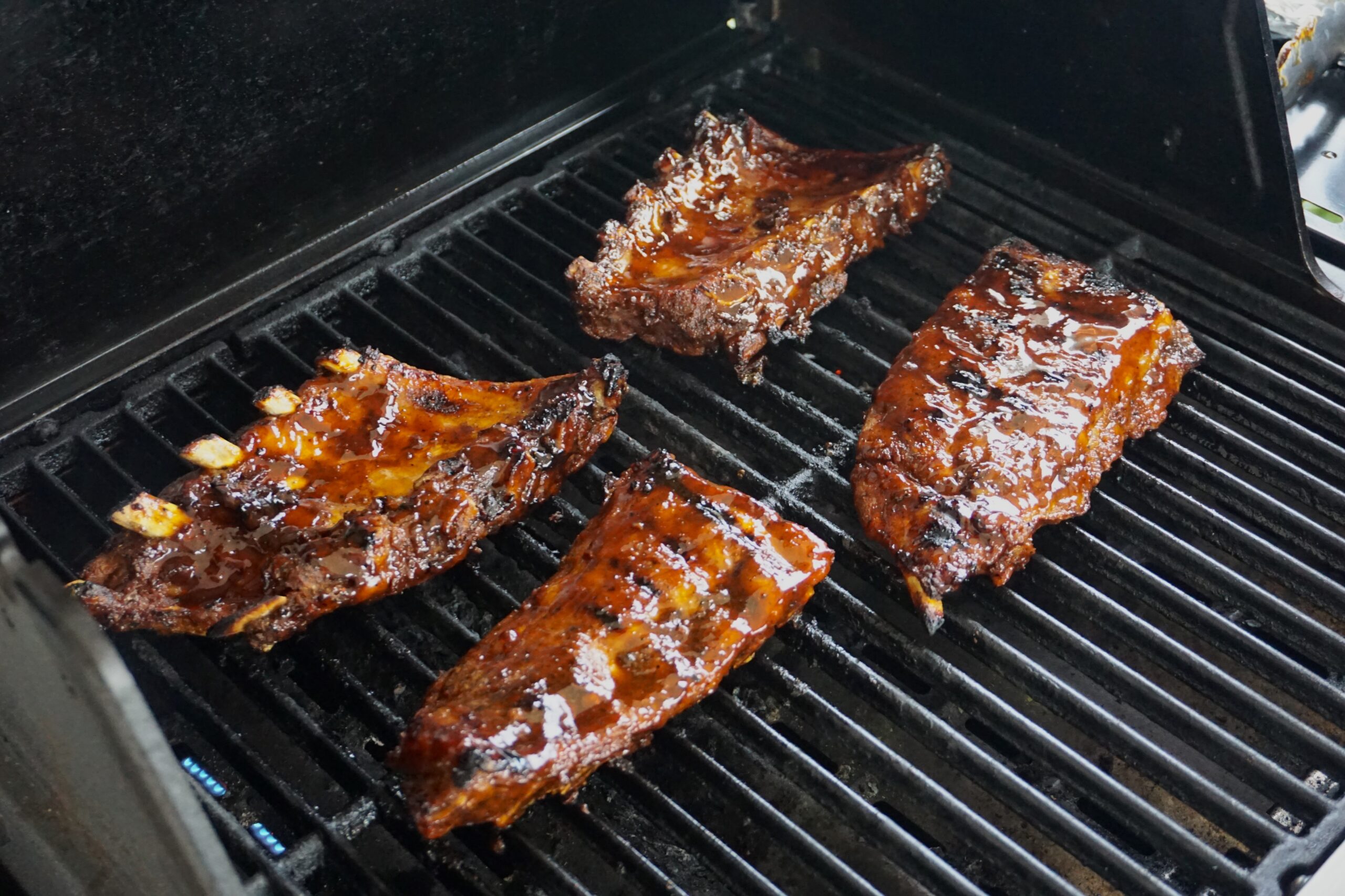 Cooking pork ribs on the grill. Pork ribs from marinade to plate.