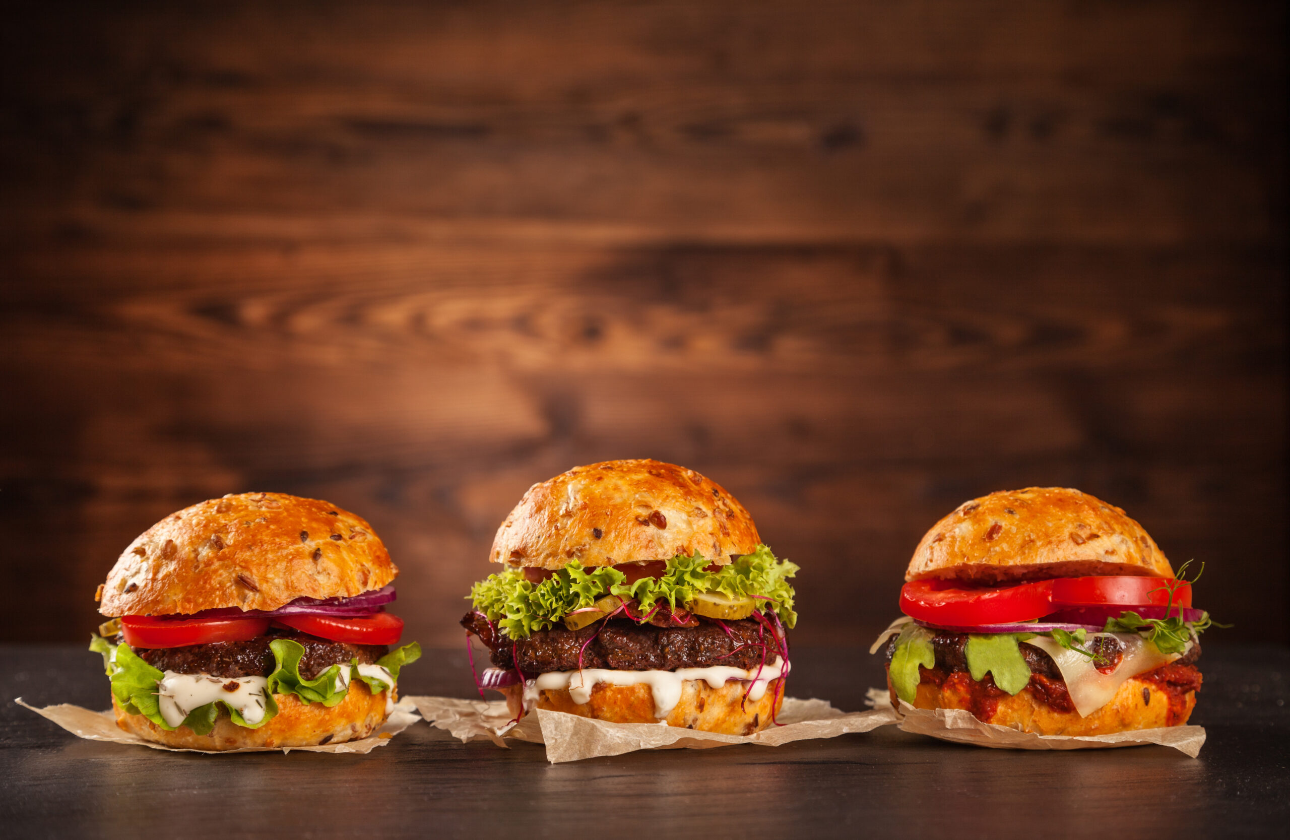 Delicious hamburgers served on wooden planks