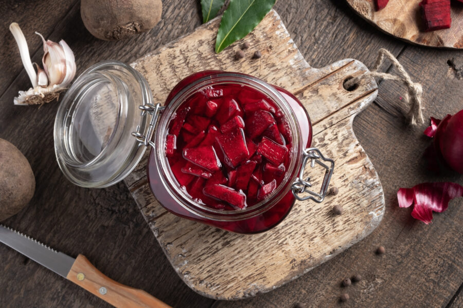 Fermented red beets in a glass jar, top view