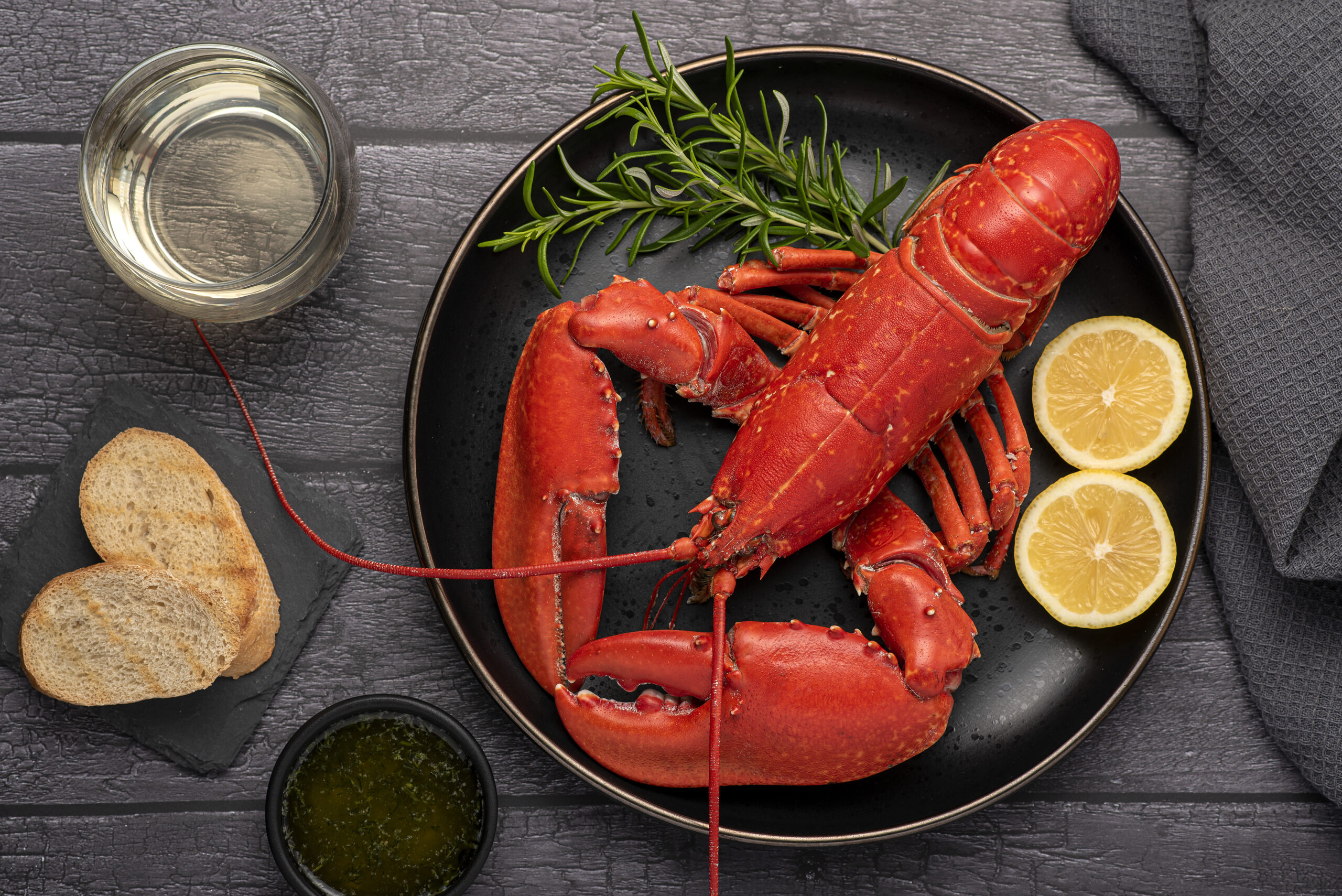 Food photography of lobster, seafood, lemon, wine, bread