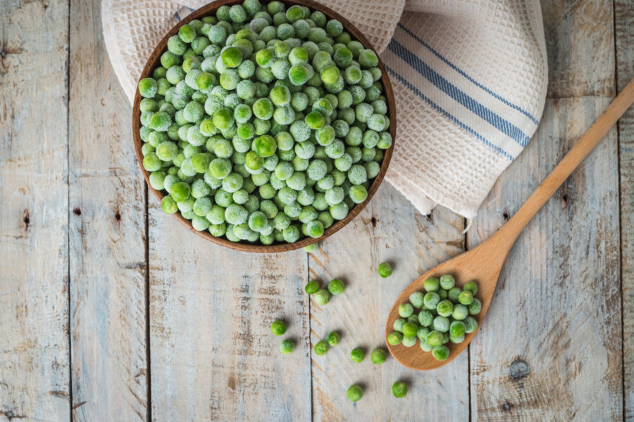 Fresh frozen peas. Vegetable food background healthy vegetarian natural meal.