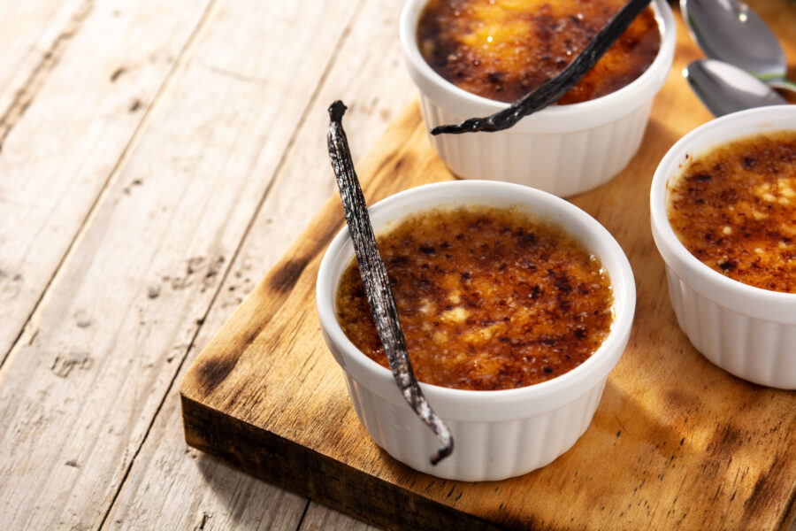 Homemade creme brulee in bowl on wooden table