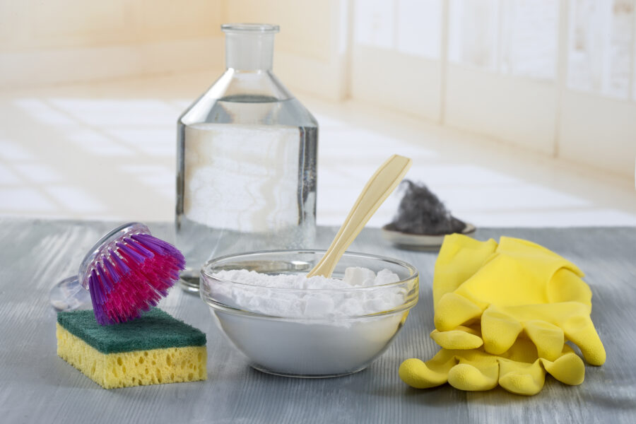 Homemade green cleaning: baking soda, vinegar, and sponge