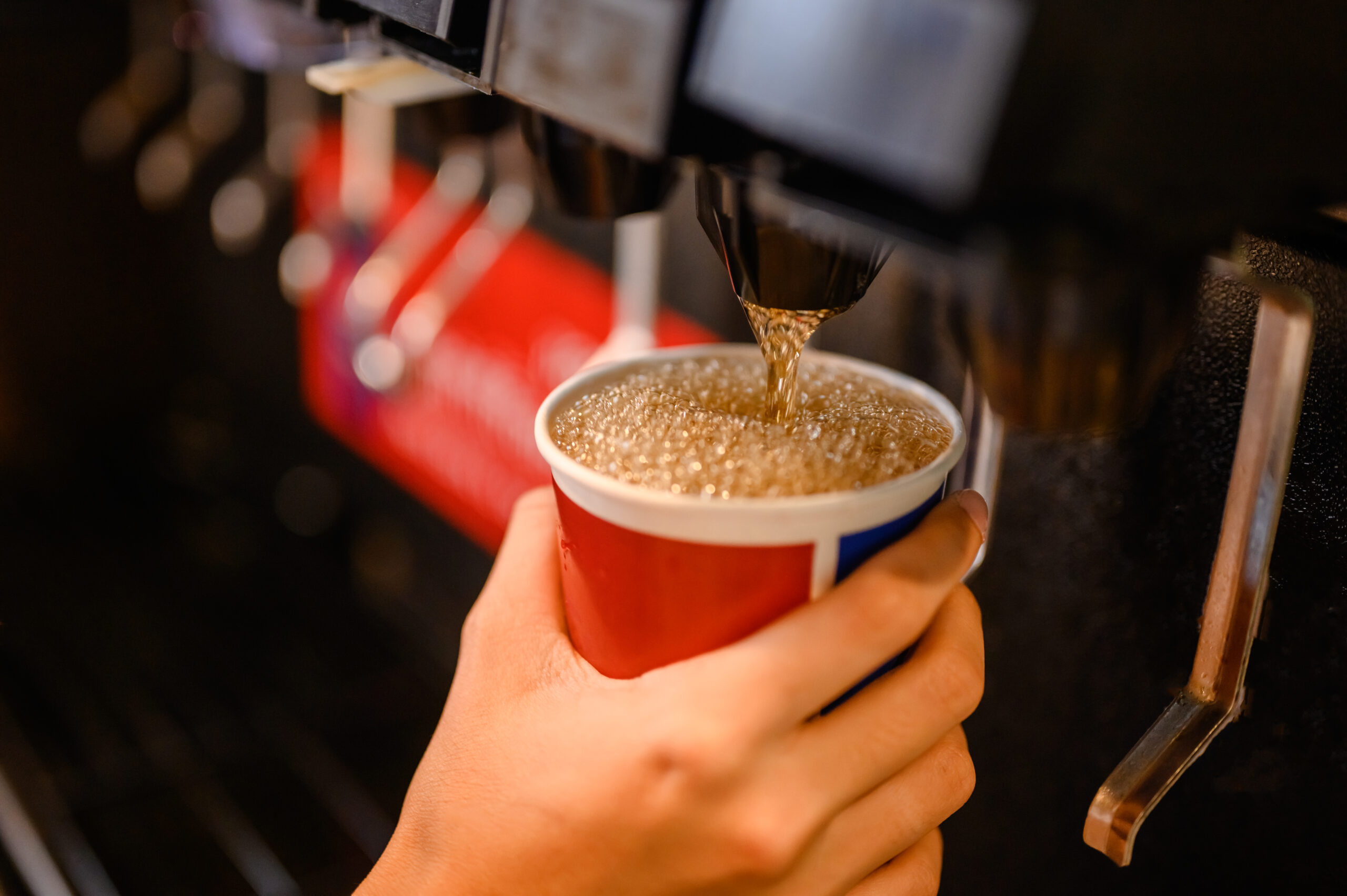 man pours a fizzy drink. cool ice soft drink cola