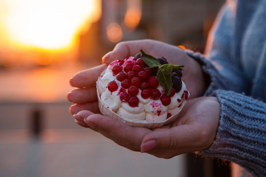 Pavlova meringue nest with berries and mint leaves