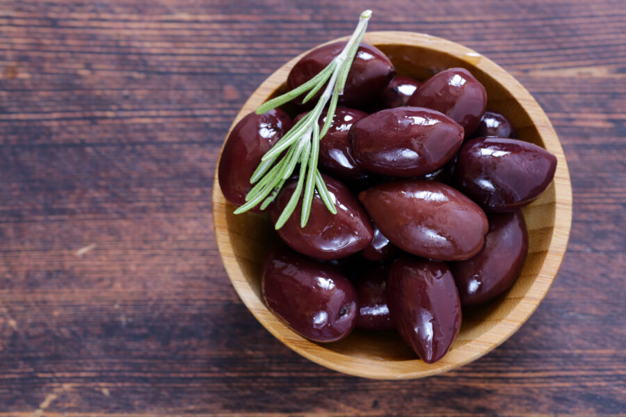 red kalamata olives on a wooden table