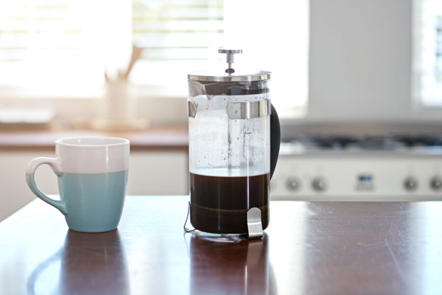 Shot of a mug and french press on a kitchen counter