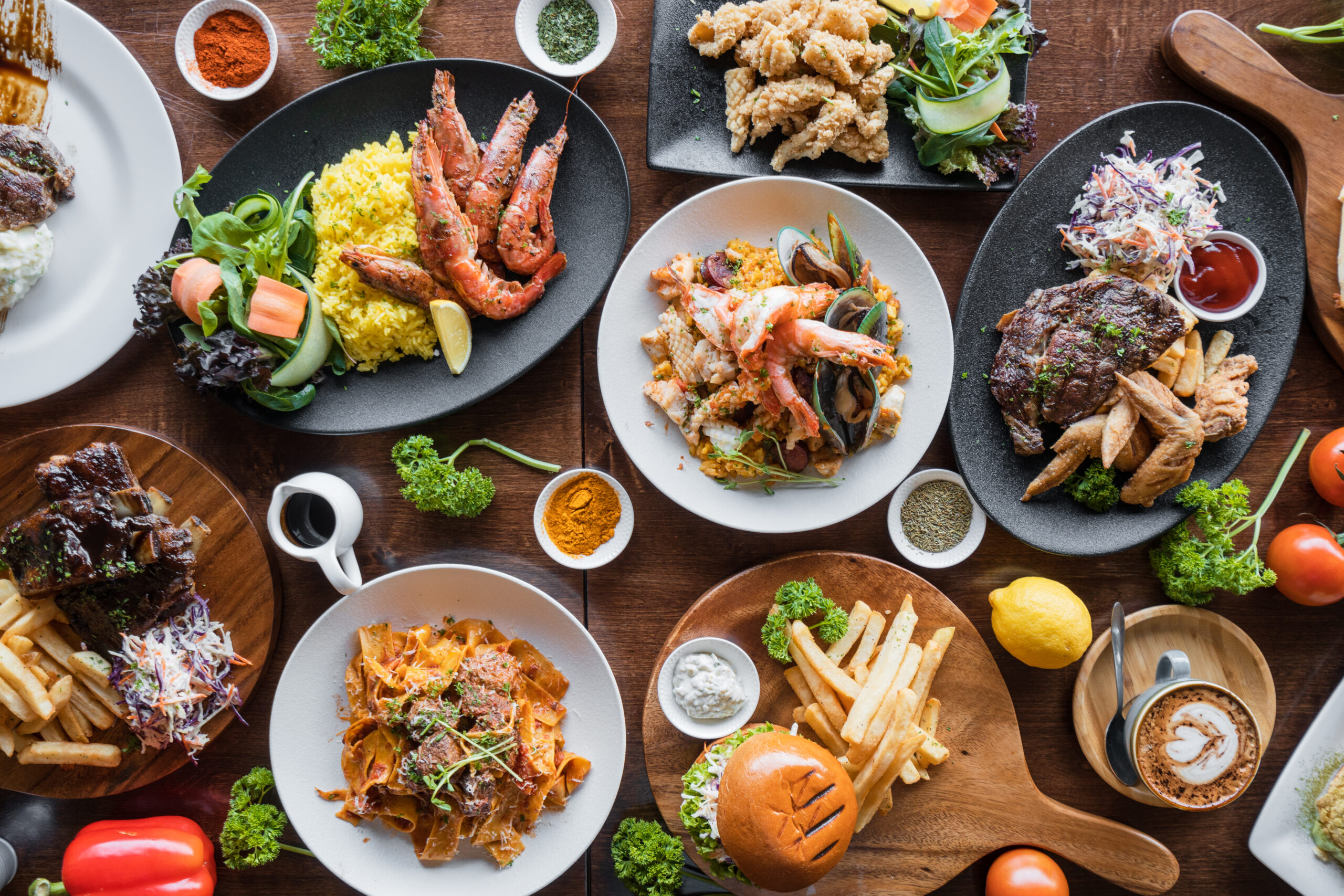 Top looking down at restaurant food spread on table.