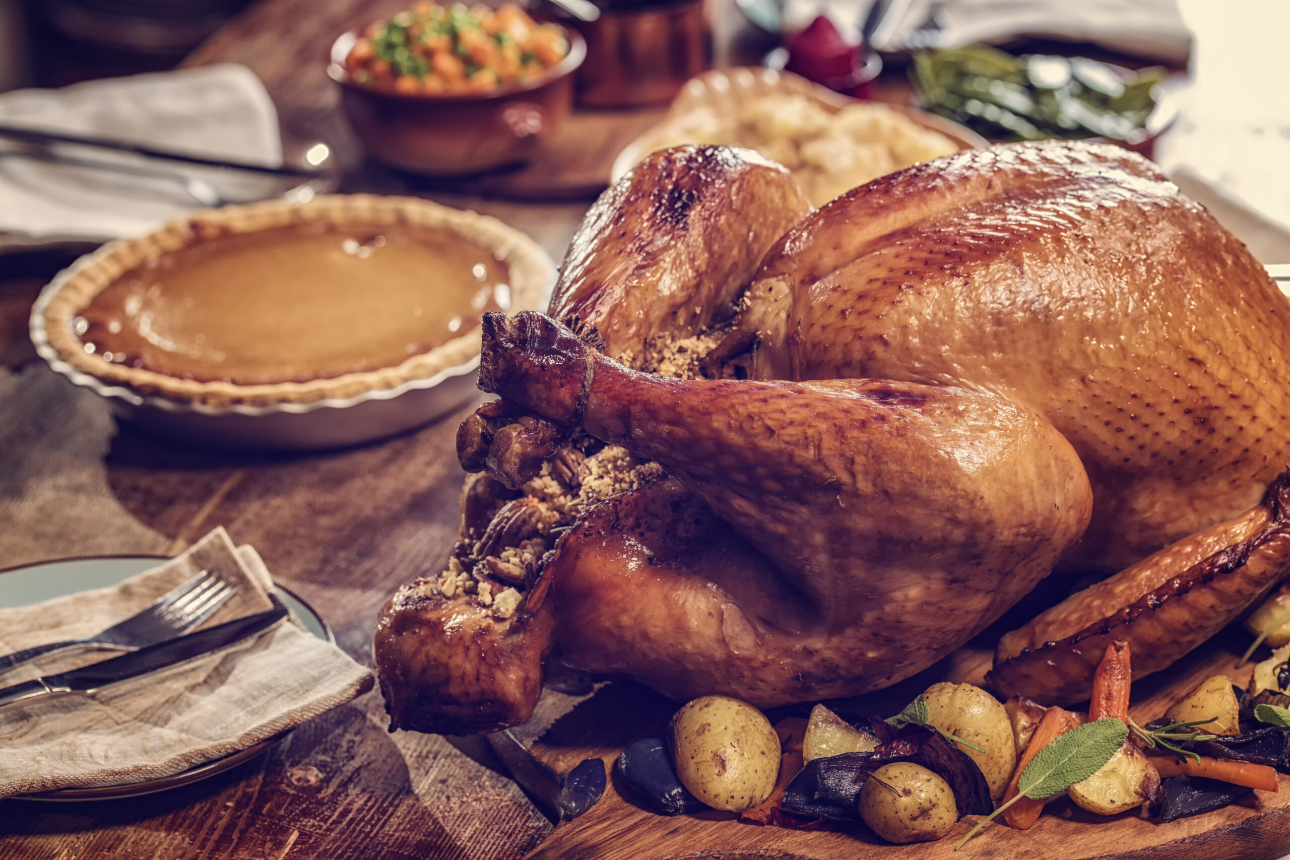 Traditional Stuffed Turkey with side dishes pecan and pumpking pie for holiday dinner