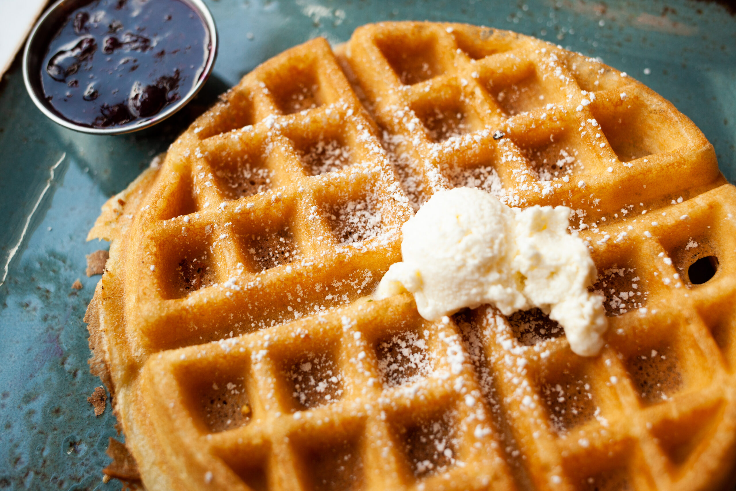 Waffle with powdered sugar, butter, mixed berry jam

Shallow DOF