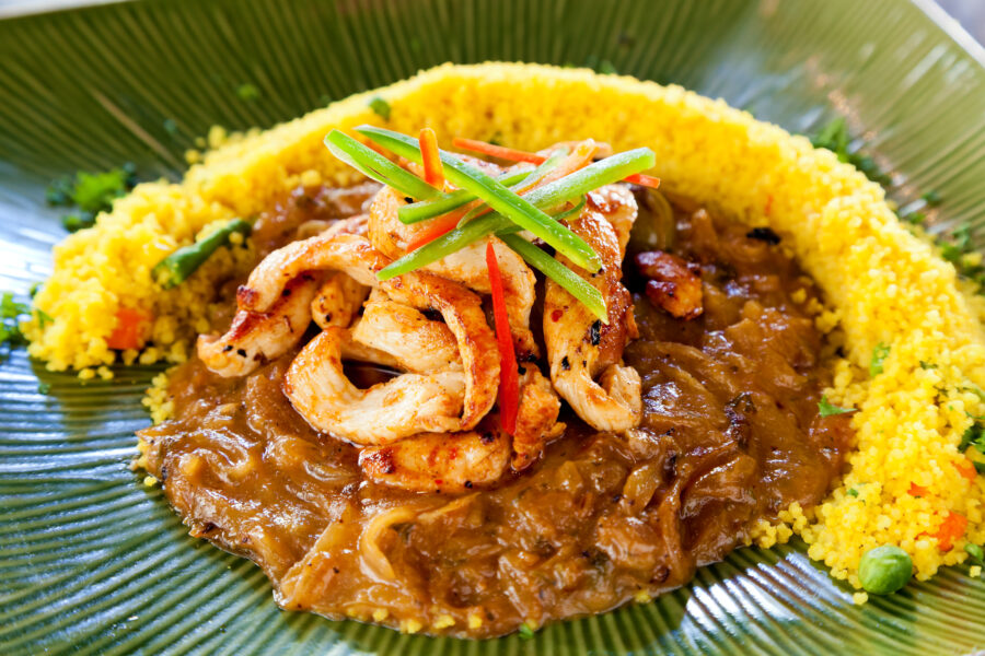 A close-up photo of yassa with chicken, a popular African dish from Senegal.