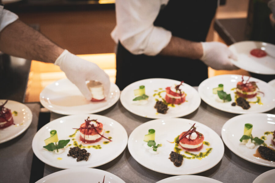 A group of chefs prepares Tomato and mozzarella salad at the hotel buffet